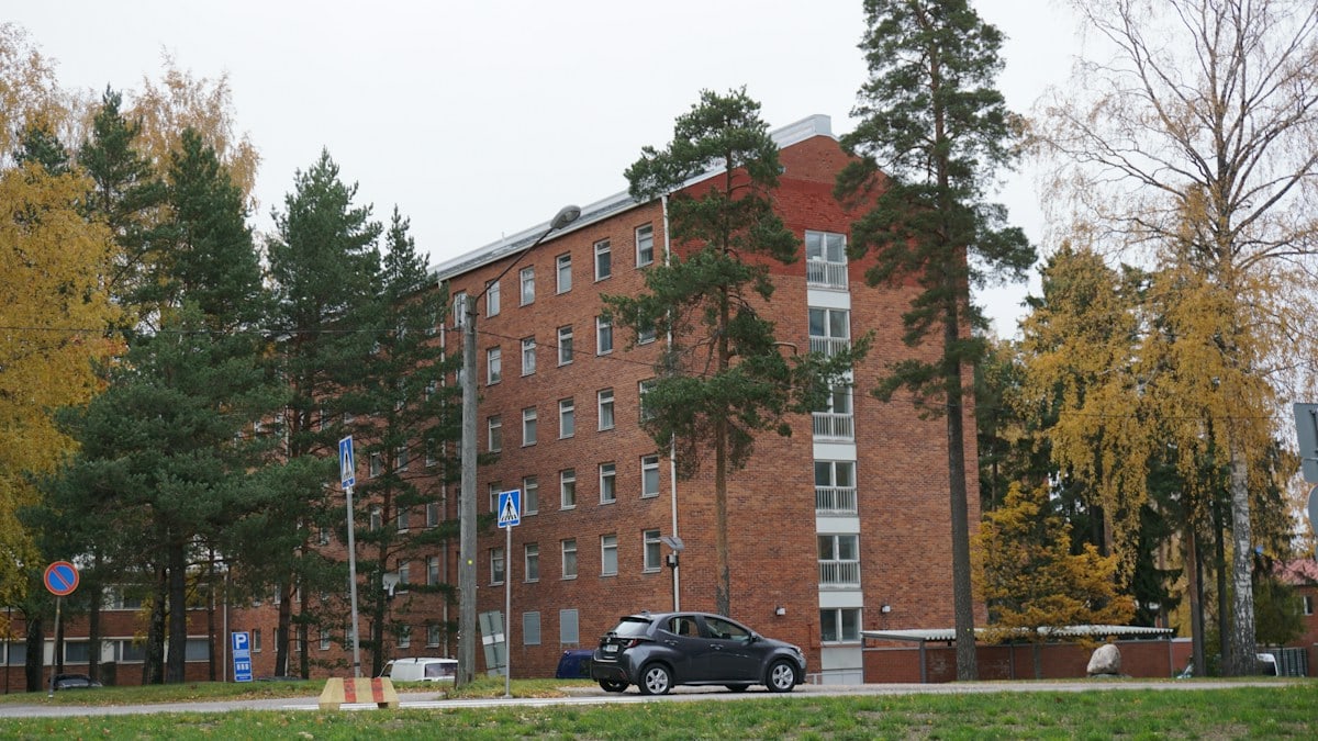 a car is parked in front of a brick building